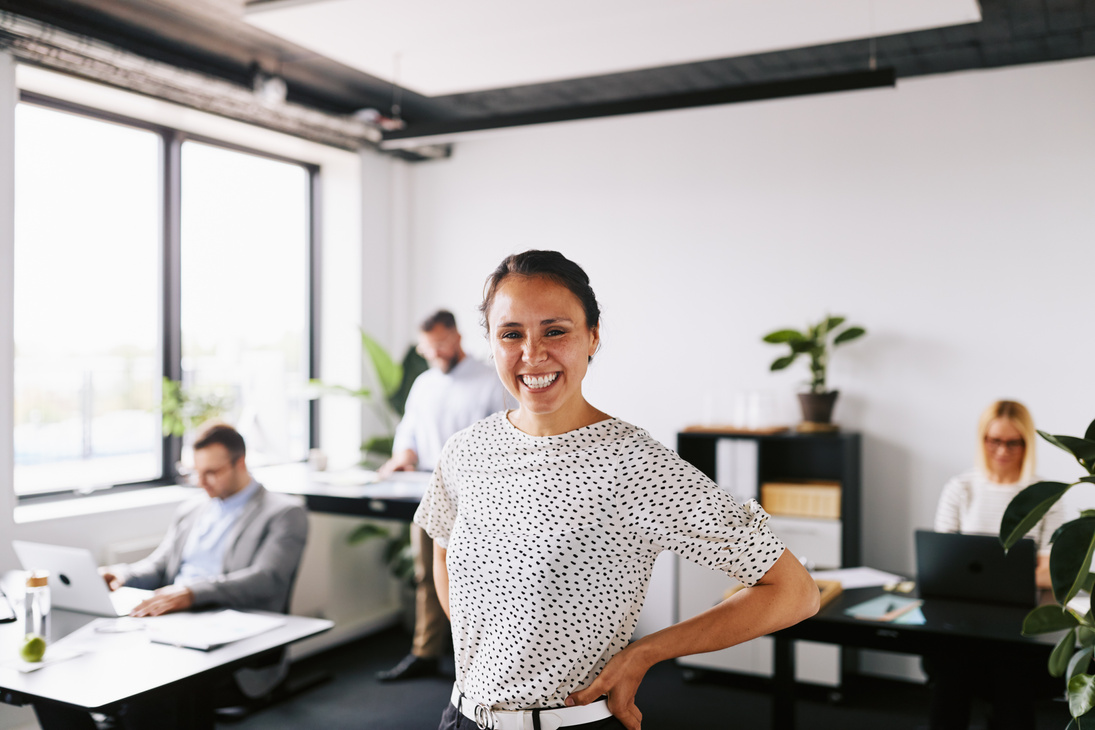 Smiling Woman Standing in the Office